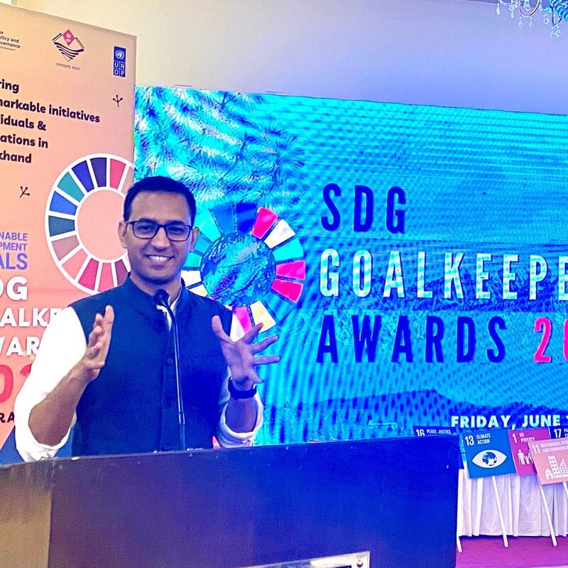 Joginder Rohilla speaking on stage